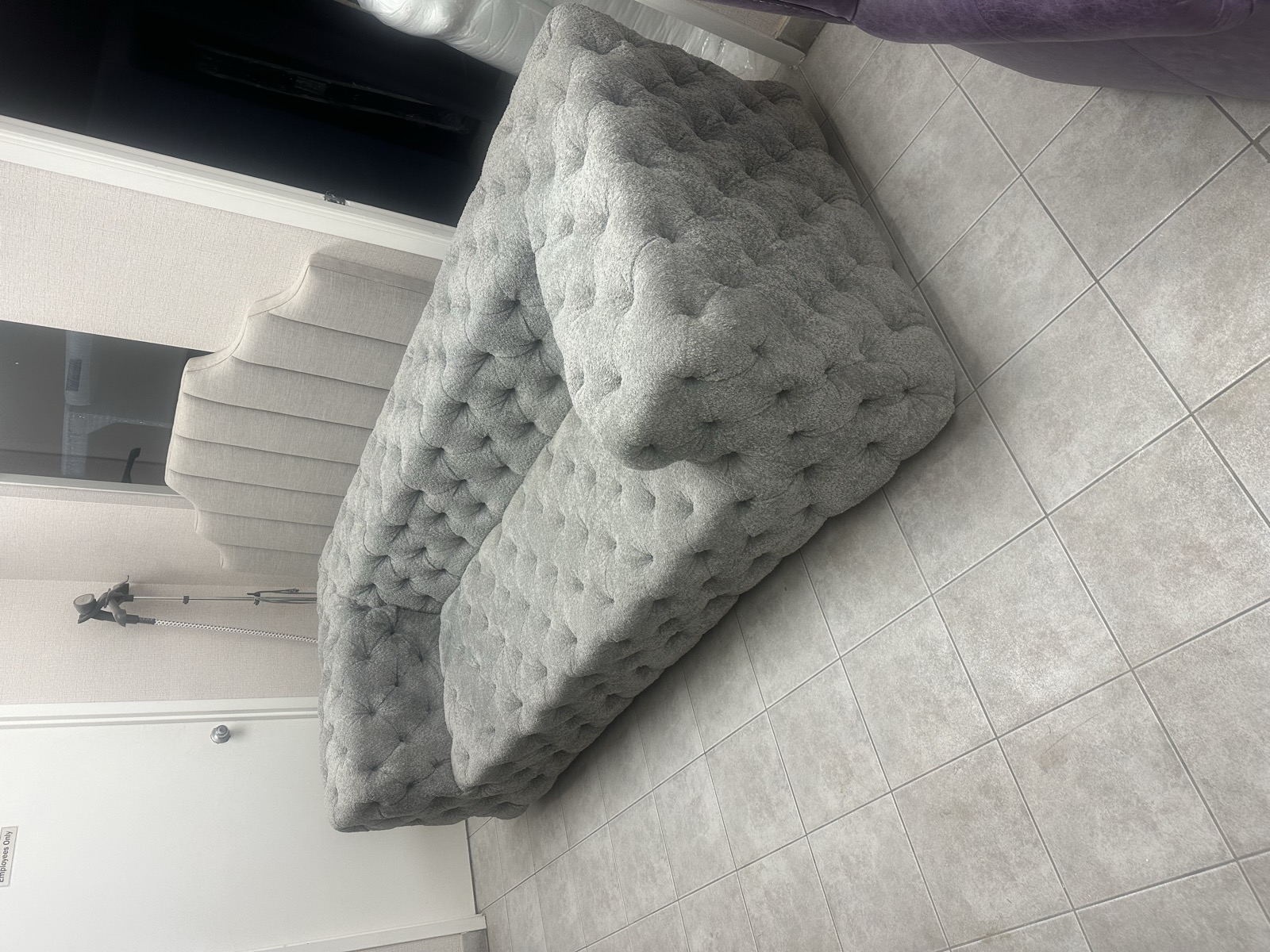 Grey tufted sofa